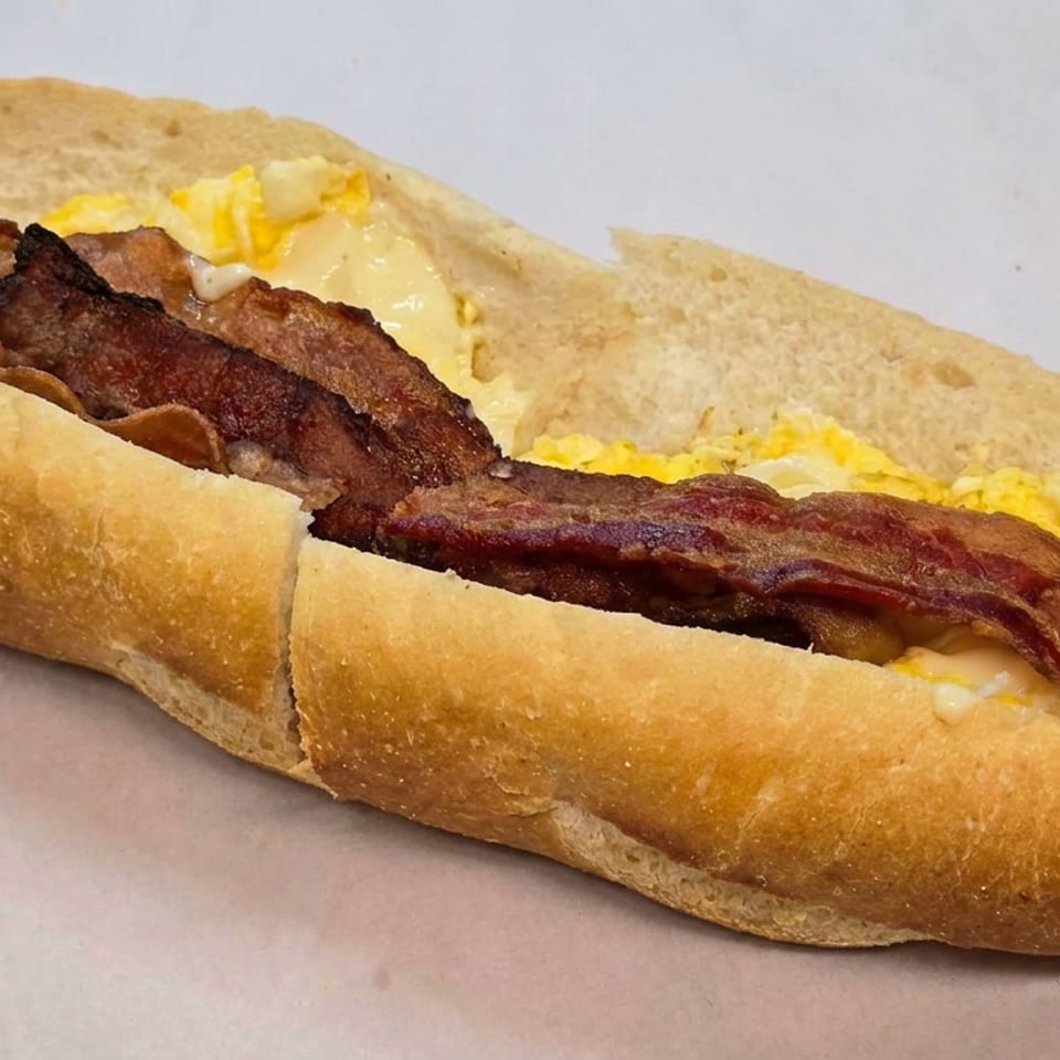 Bacon, scrambled eggs, and melted cheese served in a toasted split bread roll.